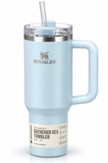 A light blue Stanley Quencher H2.0 Tumbler with a handle, clear lid, and straw on a white background.